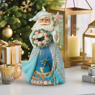 Jim Shore Heartwood Creek: Coastal Santa Holding Sand Dollar Wreath Figurine sparkle-castle