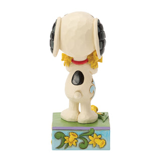 Jim Shore Peanuts: Snoopy With Bouquet of Daffodils Figurine sparkle-castle