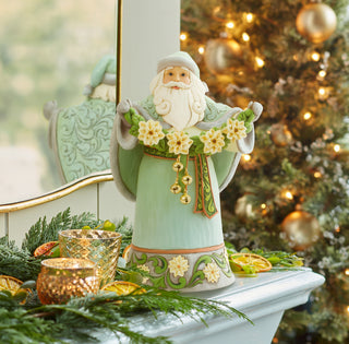 Jim Shore Heartwood Creek: Opal & Moss Santa With White Poinsettia Garland Figurine sparkle-castle