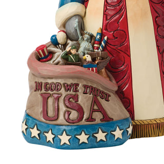 Jim Shore Heartwood Creek: Patriotic Santa With Bag of Americana Figurine sparkle-castle