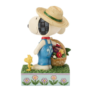 Jim Shore Peanuts: Snoopy Holding Flower Basket Figurine