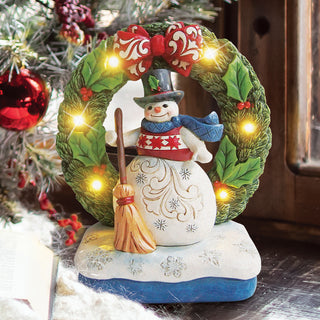 Jim Shore Heartwood Creek: Snowman by Light Up Wreath Figurine sparkle-castle