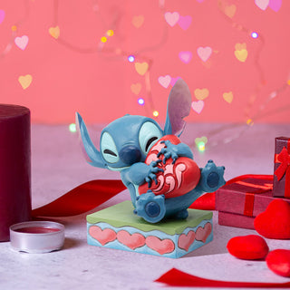 Jim Shore Disney Traditions: Stitch Hugging Heart Figurine sparkle-castle
