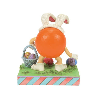 Jim Shore M&M'S: Orange M&M On Easter Egg Hunt Figurine sparkle-castle